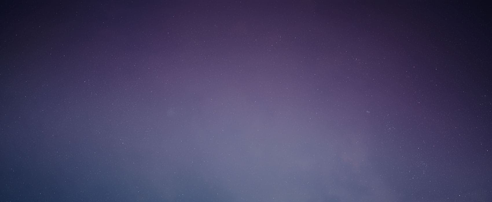 A gradient night sky with faint stars on a purple and blue background.